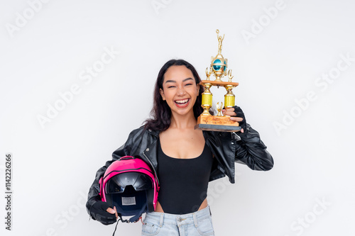 Happy female motorcycle champion holding trophy and helmet over white background photo