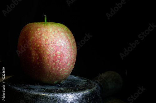 Obraz na płótnie A fresh kissabel apple fruit. Naturally pink flesh with a unique zesty taste in minimalist style on dark background. Light and Shadow, Space for text, Selective Focus. w salonie
