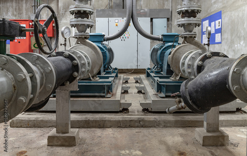 Obraz na płótnie Cold water pump of Condominium. Large blue water pumps motor and pipeline to deliver cooling water supply system into production process, Copy space, Selective focus. w salonie