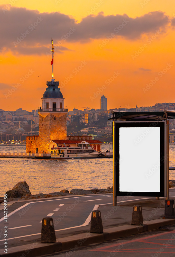Maiden's Tower in the background and bus stop advertising board in the at sunset, Istanbul, Turkey