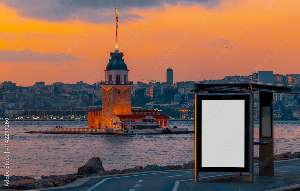 Maiden's Tower in the background and bus stop advertising board in the at sunset, Istanbul, Turkey