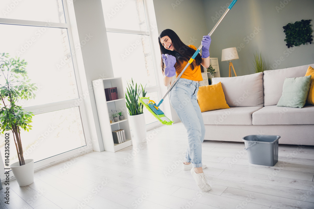 Young woman enjoying cleaning on a sunny day at home, embodying a vibrant and joyful lifestyle indoors Young woman enjoying cleaning on a sunny day at home, embodying a vibrant and joyful lifestyle indoors