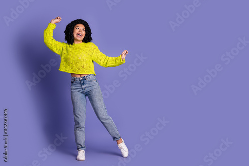 Full body photo of attractive young woman dancing have fun dressed stylish yellow clothes isolated on purple color background