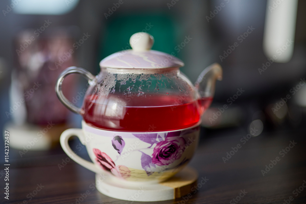 a teapot with tea on a desk with a blurred background a teapot with tea on a desk with a blurred background