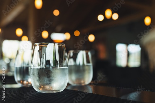 Glasses of Cold Water on a Table with a Blurred Background photo