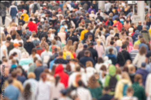 The blur effect. Background of a blurred crowd of people in the city during rush hour in the afternoon.