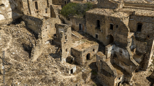 Aerial view of abandoned and destroyed houses in Craco, ghost town in province of Matera, Basilicata, Italy. The historic center was depopulated due to a landslide and has become a tourist destination