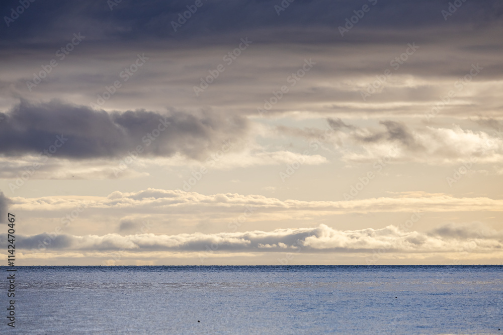 Dramatic Sky Over Calm Ocean Waters in Coastal Landscape Dramatic Sky Over Calm Ocean Waters in Coastal Landscape