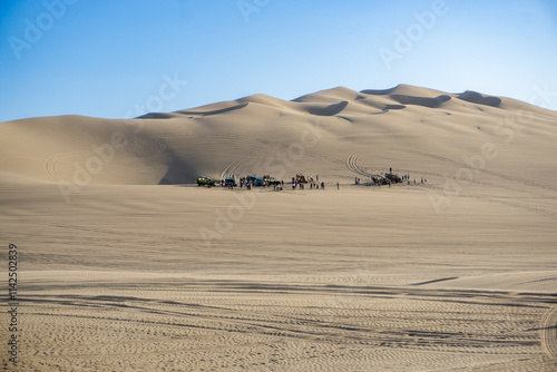 Stunning Huacachina Oasis in the Ica Desert Peru with sand dunes and adventure boogies in motion photo