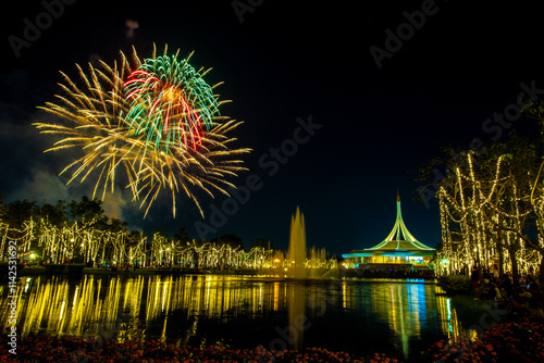 Colorful fireworks and light show at the Royal Park Suan Luang 2024 Flower Festival and the Rajamangala National Landmark building in Bangkok, Thailand photo