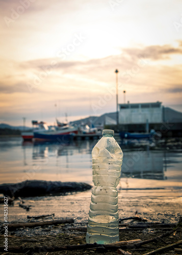 Plastic bottle in the water of a fishing port. Environment pollution concept