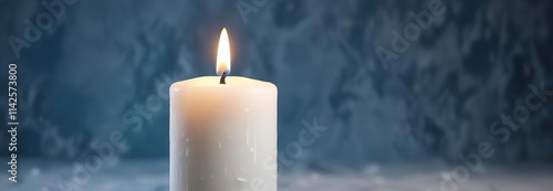 Illuminated white candle flame on abstract blue background, reflection, mystical, purity, peacefulness photo