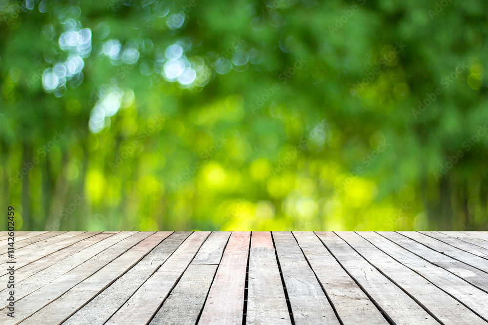 Wood floor with blurred trees of nature park background and summer season, product display montage