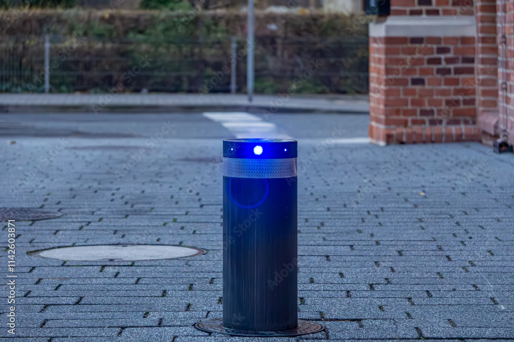 retractable entry lock with blue light. a modern blockade next to an old tenement house in the city center. retractable entry lock with blue light. a modern blockade next to an old tenement house in the city center.