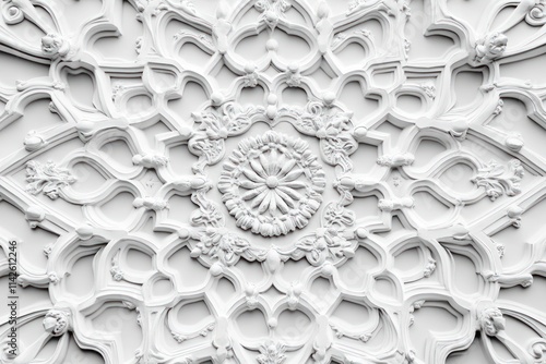 Intricate white plaster ceiling rosette with floral and arabesque patterns. photo