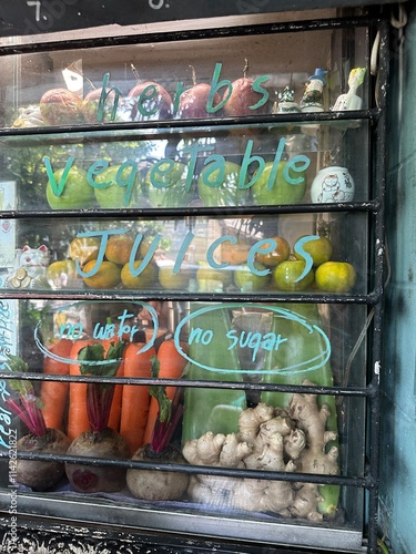 A vibrant fruit stand featuring a sign that reads fresh fruit shake