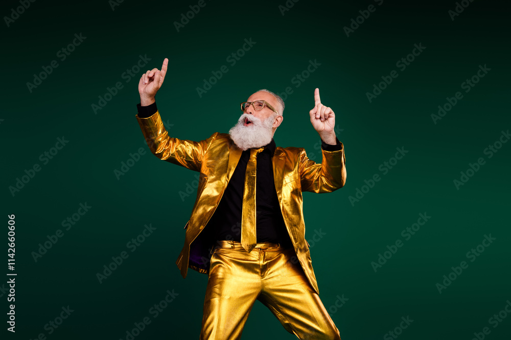 Fototapeta premium Charismatic elderly man in golden suit celebrating a joyous occasion with style against green backdrop