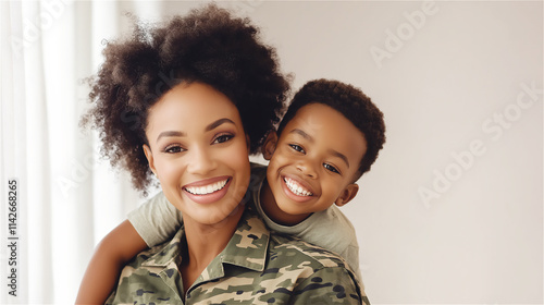 A cheerful woman in a military uniform smiling while her young son playfully hugs her from behind, capturing a joyful family moment indoors. photo