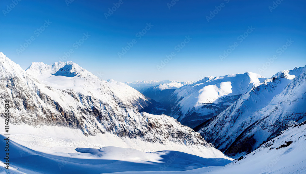 Fototapeta premium A panoramic view of majestic snow-covered peaks stretching across the horizon under a clear blue sky, with crisp, vivid details capturing the serene alpine landscape.