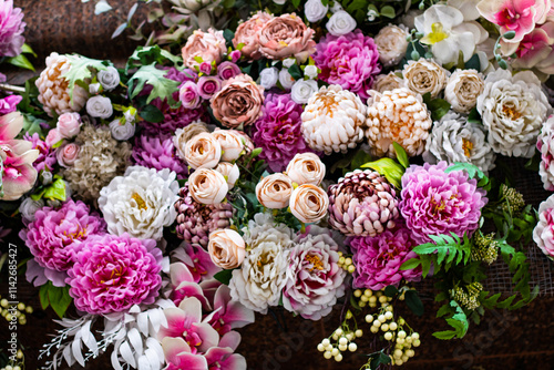 Floral design with many purple and lilac artificial roses and peonies photo