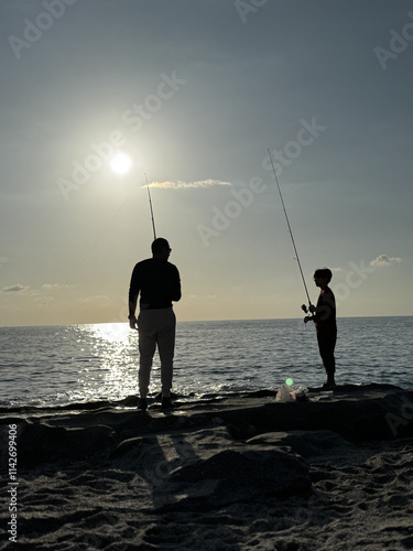 silhouette of a fisherman at sea sunset calm. High quality photo photo