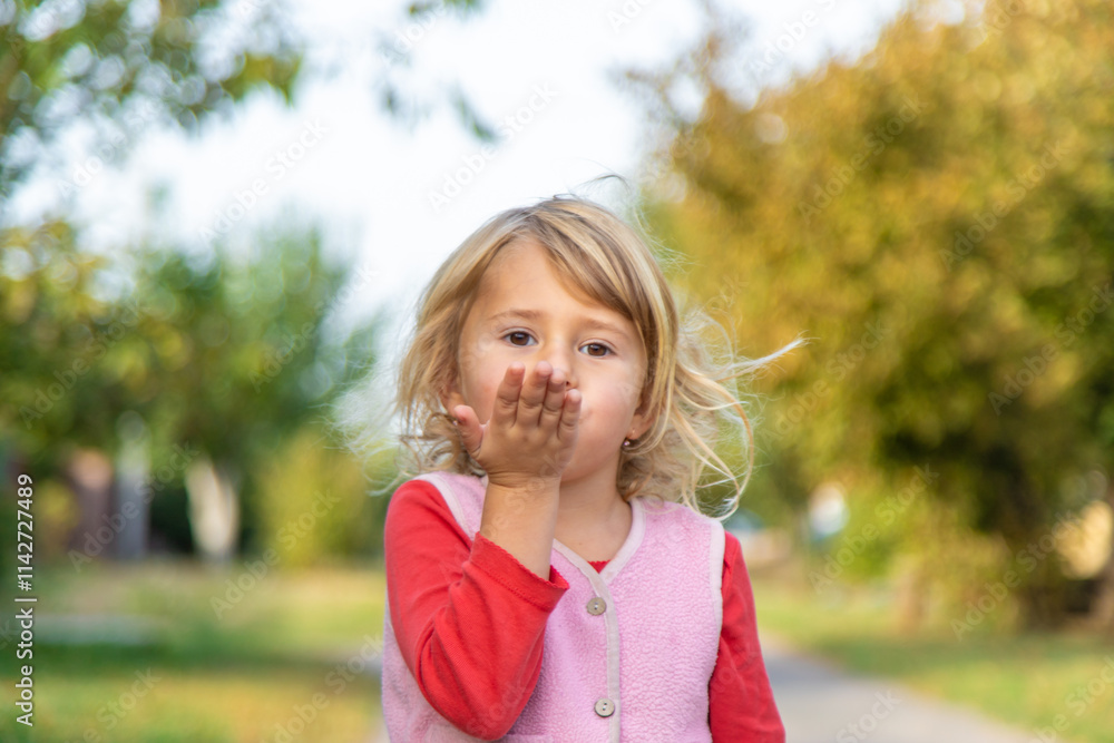 Child blowing a kiss. Selective focus. Child blowing a kiss. Selective focus.