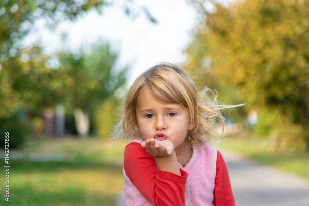 Child blowing a kiss. Selective focus. Child blowing a kiss. Selective focus.