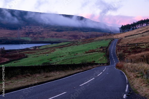 Minor road in countryside with sunrise colours and cloud inversion photo