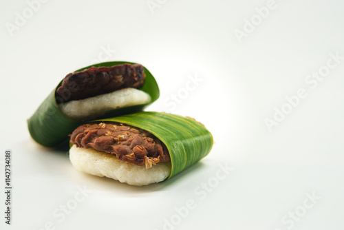 Traditional Indonesian Jadah Tempe Snacks Wrapped in Banana Leaves Presentation photo