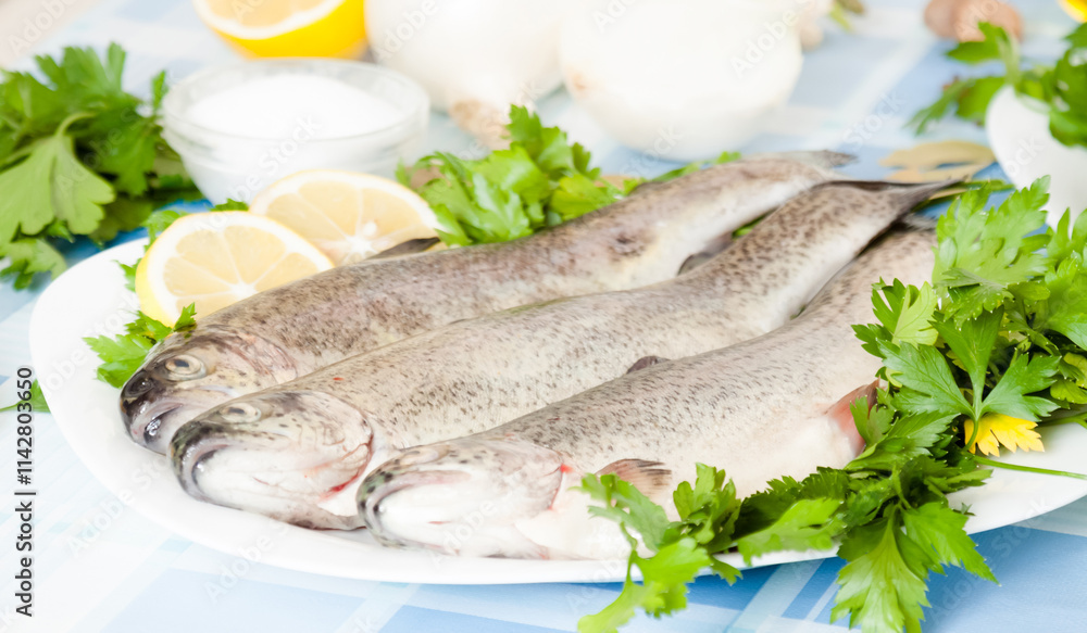 Lemon, parsley, fish and onion lying on the plate Lemon, parsley, fish and onion lying on the plate