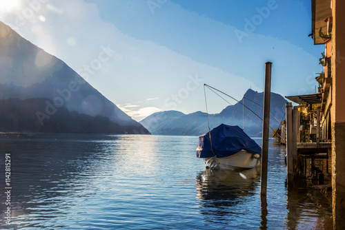 Amazing view on lke Lugano with  part of buildig ( small hotel?) and moored motorboat photo