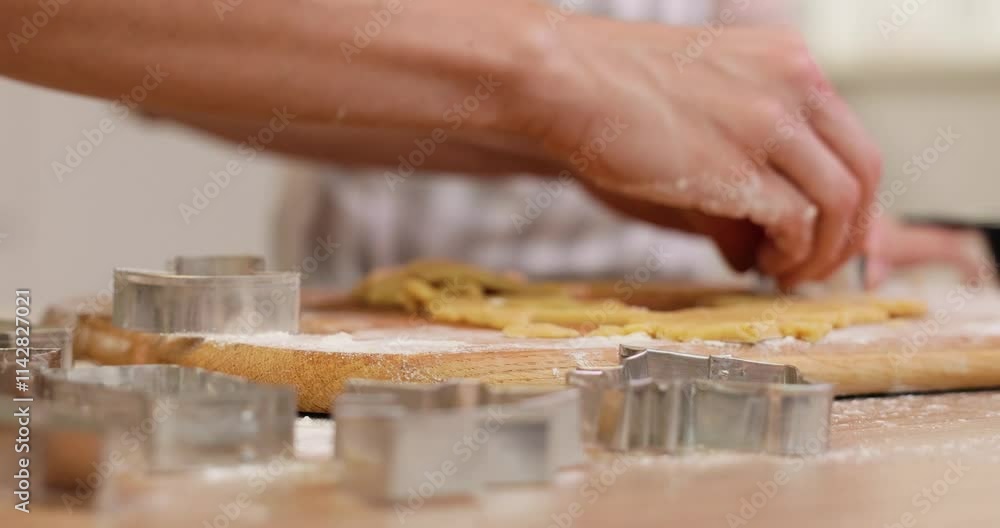 mother and little child daughter cutting cookies of raw gingerbread dough in kitchen. close up mother and little child daughter cutting cookies of raw gingerbread dough in kitchen. close up