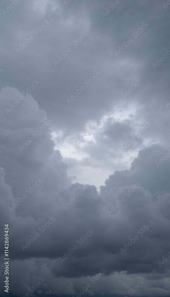 Dramatic cloudy sky with varying shades of gray and hints of light peeking through
Dramatic cloudy sky with varying shades of gray and hints of light peeking through