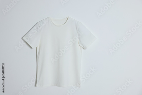 One t-shirt on light background, top view