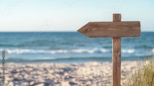 Wallpaper Mural Weathered wooden sign pointing toward the ocean with soft sand and gentle waves at a tranquil beach during a sunny afternoon Torontodigital.ca