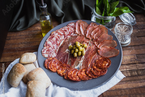 plate of serrano ham with olives