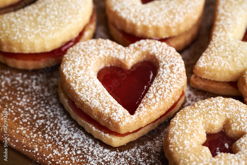 Heart shaped homemade Linzer Christmas cookie filled with strawberry marmalade and dusted with sugar