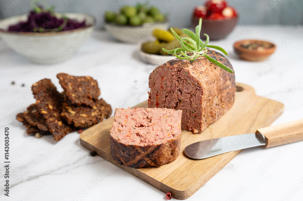Liver pate slices on a wooden cutting board with spices. Liver pate slices on a wooden cutting board with spices.