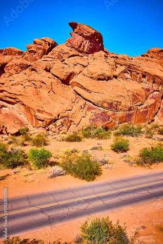 Rugged Red Rock Desert with Cracked Road Aerial Tilt