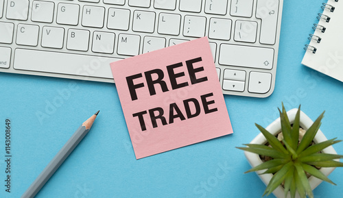 A pink sticky note with the word Free Trade written on it is placed on top of a