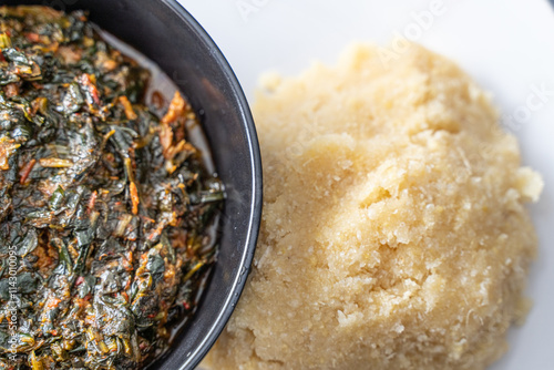 Nigerian Spicy vegetable soup and Eba fufu ready to eat photo