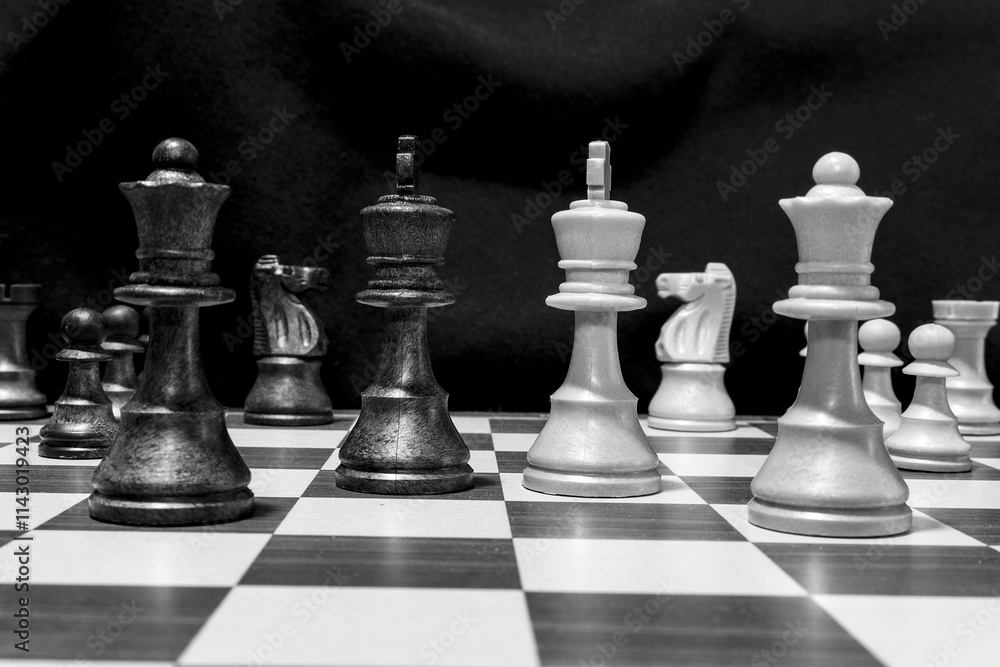 Chessmen photographed on a chessboard with a dark background Chessmen photographed on a chessboard with a dark background