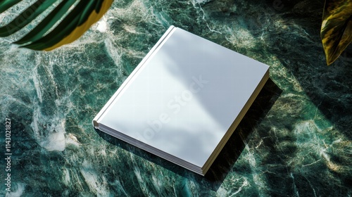 Blank magazine mockup on a green marble stone coffee table with a shadow overlay.