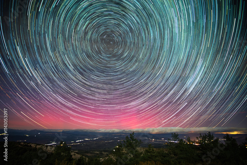 Принти на полотні Vibrant star trails and northern lights paint the night sky above Serra Del Montsec, Lleida, Spain