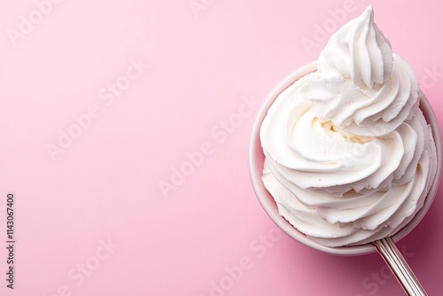 Whisk with whipped cream on pink background, closeup. Space for text  photo