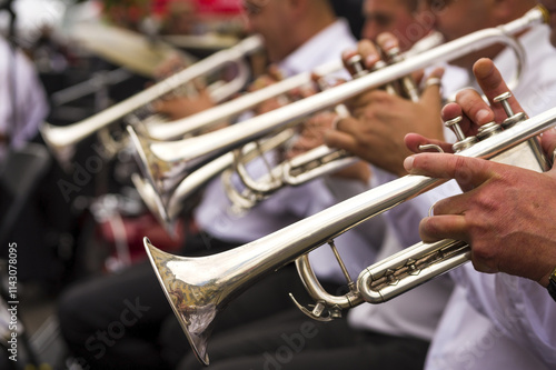Wind instruments. Hands on musical instruments. Musicians play pipes.  Hands of man playing the trumpet in the orchestra