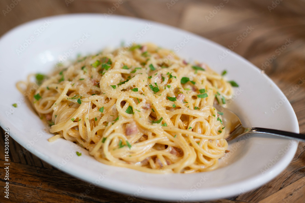 Carbonara pasta, spaghetti with pancetta, egg, hard Parmesan cheese and cream sauce. Traditional Italian cuisine. Pasta alla carbonara. Carbonara pasta, spaghetti with pancetta, egg, hard Parmesan cheese and cream sauce. Traditional Italian cuisine. Pasta alla carbonara.