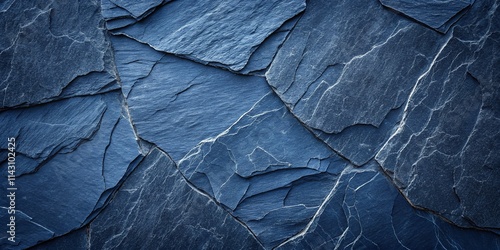 Dark blue slate rock texture background with rough and cracked stone layers, creating a natural, rough surface. Abstract design.
