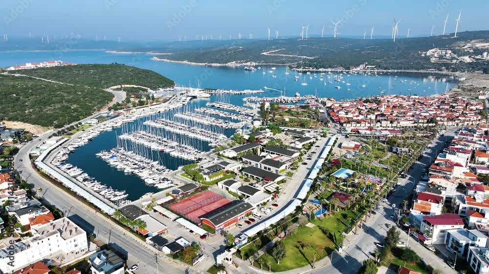 Aerial high-quality view of the historical castle, fishing port, coastline and historical village houses of Izmir tourist village Sigacik Aerial high-quality view of the historical castle, fishing port, coastline and historical village houses of Izmir tourist village Sigacik