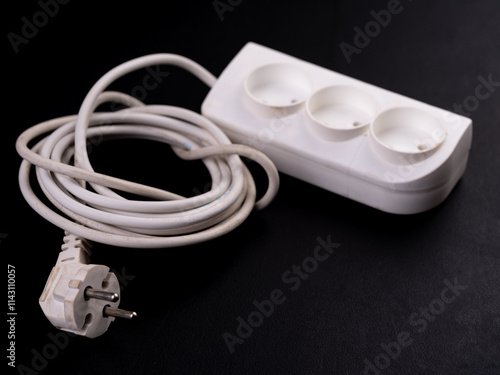 Electrical extension cord on a dark background. photo